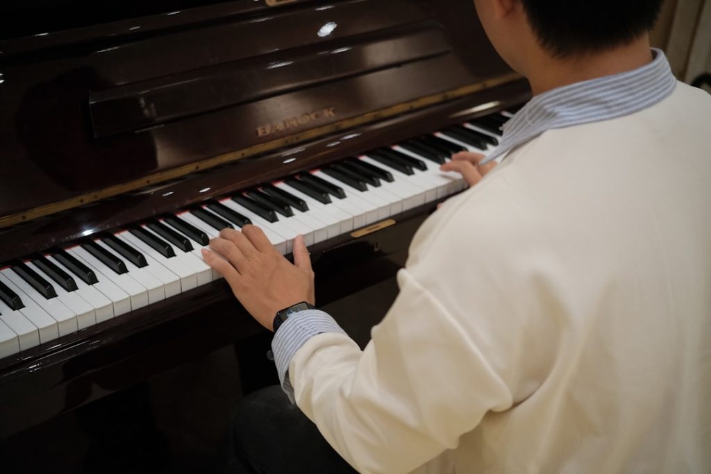 person-playing-a-piano-with-hands-on-keys-btjwpy0w674